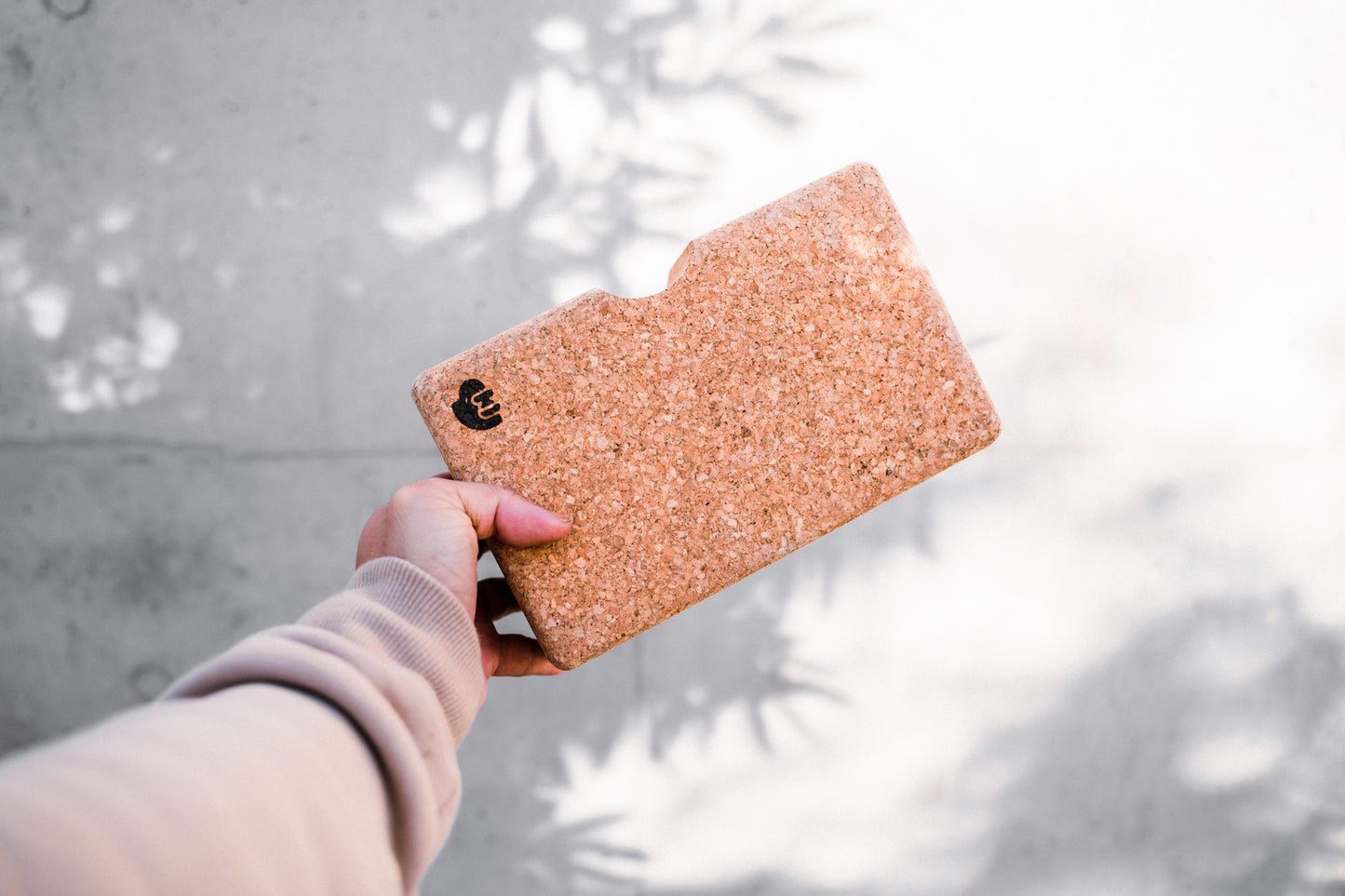 Hand holding the cork block.