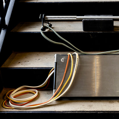 Harambe CyberPlate, CyberBar, and resistance bands arranged on steps.